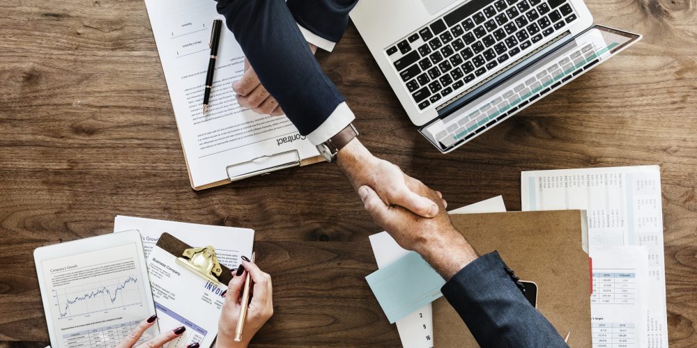 Business people shaking hands together